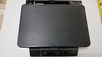 Black Epson XP-340 printer closed with logo visible