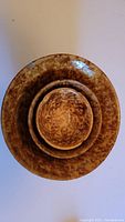 Top view showing all three Bennington bowls nested together with their brown speckled pattern.