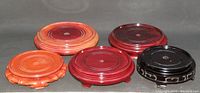 Overview of all five Asian wooden vase bases showing variety in size and finish