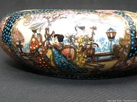 Close-up side view showing detailed traditional Japanese hand-painted figures in bright colors with gold accents on the ashtray