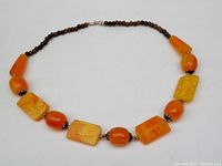 Full view of the vintage bakelite necklace showing the variety of bead shapes and colors arranged symmetrically.