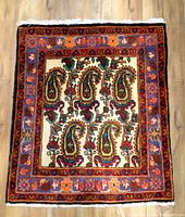 Front view of the vintage Persian small carpet showing overall pattern and design