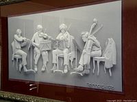 Close view of the 3D print depicting four musicians in vintage attire playing string instruments in a rehearsal setting, showing detailed relief and embossed signature and date.
