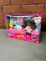 Front view of unopened Barbie Bathtime Fun Kelly doll playset in box showing doll and bath accessories