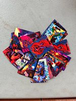 Fanned view of about 27 glossy Marvel Masterpieces trading cards featuring various Marvel heroes and villains with colorful artwork.