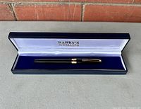 Vintage black Sheaffer pen in Barry's Jewellers box showing full pen with gold accents.