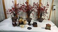 Photo showing entire fall decor patio collection including three faux berry plants in brown vases, various small seasonal decorative items, and vintage style clock.