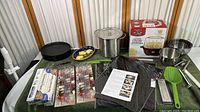 Wide view of collection showing stock pot, mixing bowls, trays, skewers, knife, wax paper, parchment paper, and popcorn popper