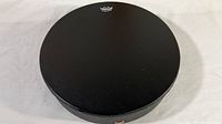 Top view of the drum showing black synthetic drumhead with Remo logo and Buffalo Drum text.