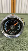 Front view of the Sun Super Tach RPM gauge showing dial, markings and needles clearly.