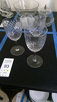 Side view of three crystal goblets showing the oval cut pattern on the bowls and clear stems and bases.