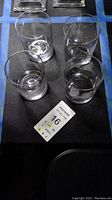 Set of 4 Double Old Fashioned glasses arranged in a square on a table.