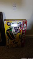 Photo of boxed Chevy Truck Racing slot car track set showing front of the box with artwork of two racing Chevy trucks and track layout.
