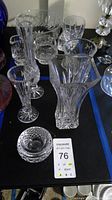 Full view of the lot showing vases and bowls in clear crystal with cut designs.