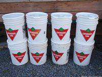 Eight white 5-gallon Canadian Tire buckets stacked in two rows of four showing front logo and lids