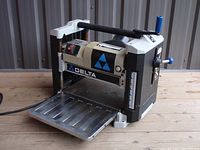 Front-left perspective showing infeed table extended and control panel