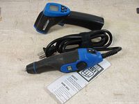 Mastercraft digital temperature reader with Power Fist electric engraver and manuals laid out on surface.