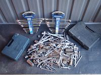 Full lot showing two sets of combination wrenches on holders, two Mastercraft carrying cases, and pile of loose tools including ratchets, sockets, extensions, and wrenches.