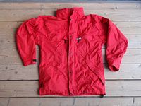 Front view of men's Taiga Gore-Tex red rain jacket size large laid flat