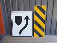 Front view of both street signs placed side by side showing their graphics and condition.