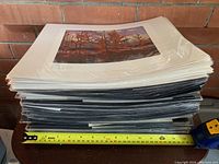Stack of Group of Seven prints with mats and sealed in plastic, showing thickness and quantity.