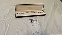 Full view of tennis bracelet in display box showing overall length and presentation