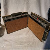 Two Toyo portable 8-track stereos side by side, showing fabric speaker panels and top handles.