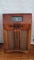 Front view of Viking vintage tube radio showing wooden cabinet, tuning dial, control knobs, and woven speaker grill.