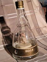 Clear view of the bottle with ballerina inside and label visible.