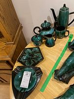 Full view of 7-piece Blue Mountain Pottery dripware set on table showing coffee pot, teapot, sugar bowl, creamer, cup, and two ashtray/trays
