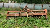 Front view of rotary tiller showing rotor housing and tines