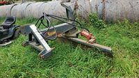 Front-angle view showing overall swing blade attachment and hitch mounting