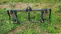 Front view of steel bale spear frame showing three tine pockets and spear insertion point