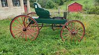 Side view of restored green and red McLaughlin buggy