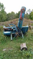 Side view of full snowblower attachment showing entire frame, chute and augers