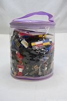 Clear zippered bag filled with a variety of Lego blocks and pieces in multiple colors and shapes.