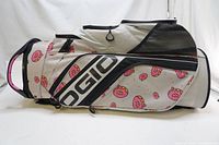 Side angle showing the donut pattern and multiple zippered pockets on the bag, with visible Ogio branding.