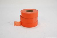 Three orange flagging tape rolls with one partially unrolled strip, showing width and texture.