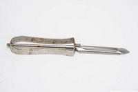 Vintage floating blade vegetable peeler lying flat showing side profile and blade assembly.