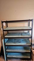 Full view of metal shelving unit with five stained wood shelves, upright and assembled.