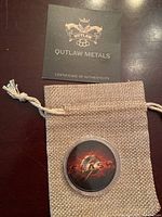 Outlaw Metals Certificate of Authenticity card and burlap pouch with coin inside plastic protective case showing Flash custom design.