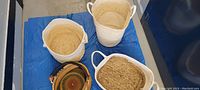 Overview of the four baskets showing two tall white baskets and two natural fiber baskets.