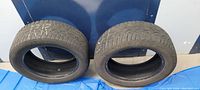 Two General Tire winter tires side by side showing the tread and sidewalls.