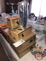 Stack of Pampered Chef Valtrompia bread tubes boxes and Chilzanne glass bowl with lid on table