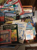 Top view of stacked educational kids books covering history, science, Canada, and storybooks.