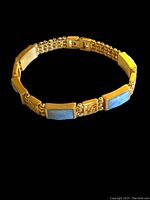 Full view of the gold plated bracelet with jade panels showing the linked design and clasp.