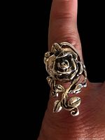 Ring shown on finger, clearly displaying 3D rose and leaf design