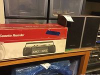 Side of box showing features of GE Stereo Dual Cassette Player.