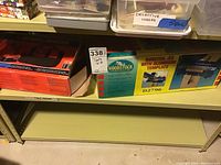 Shelf with boxed Woodstock Dovetail Jig D2796 and Black & Decker cordless drill box