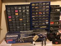 Mastercraft compact reciprocating saw boxed with hardware storage racks and Black and Decker battery packs